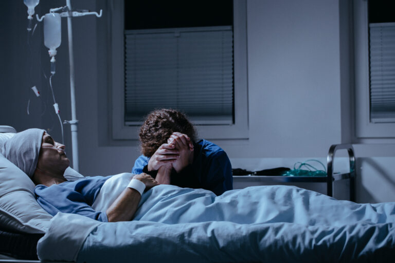 Woman comforts ill family member