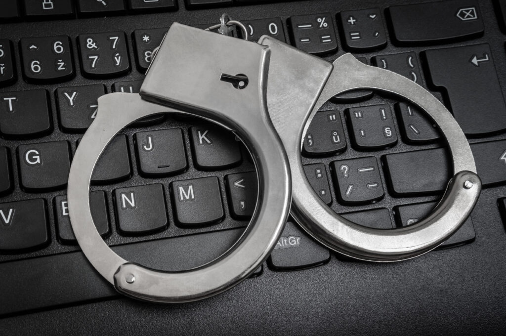 Handcuffs on keyboard (Courtesy of andriano_cz)