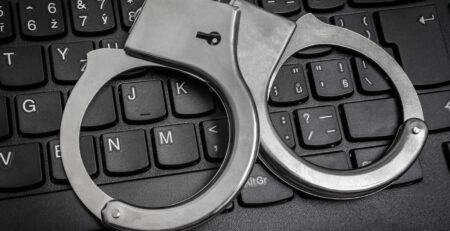 Handcuffs on keyboard (Courtesy of andriano_cz)
