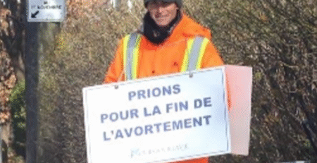 Brian Jenkins wearing a sandwich board reading “Let us pray for the end of abortion" (Courtesy of Brian Jenkins)