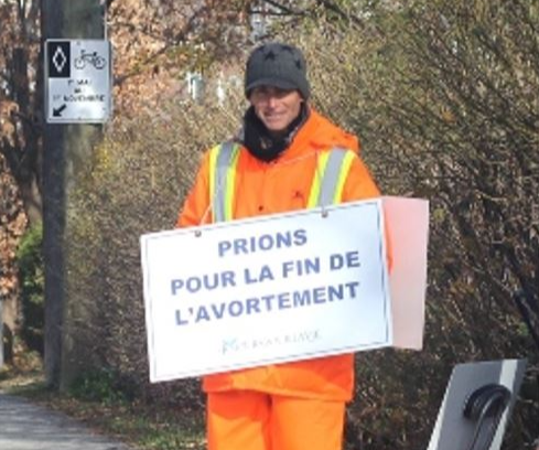 Brian Jenkins wearing a sandwich board reading “Let us pray for the end of abortion" (Courtesy of Brian Jenkins)