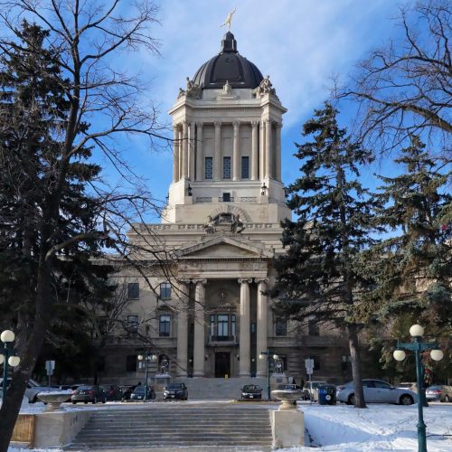 Winter view on Manitoba Legislature building. Winnipeg, Manitoba, Canada. This neoclassical building with the Golden Boy statue on its cupola was designed and built by Frank Worthington Simon in 1920.